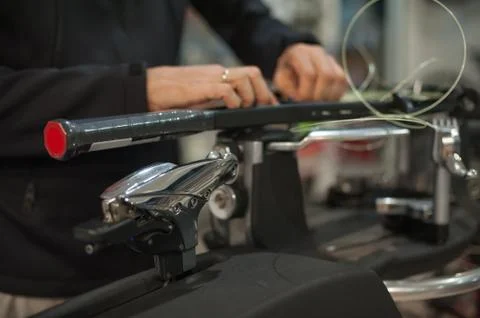 Close up of tennis stringer hands doing racket stringing Stock Photos