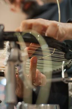 Close up of tennis stringer hands doing racket stringing Stock Photos