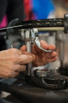 Close up of tennis stringer hands doing racket stringing Stock Photos