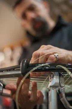 Close up of tennis stringer hands doing racket stringing Stock-Fotos