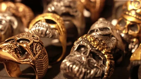 Close-up of terribly gold and silver skull rings. Skull rings that bikers or Stock Footage 194383629