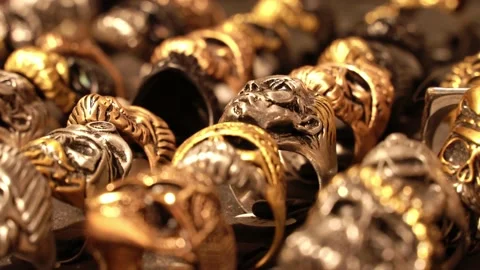 Close-up of terribly gold and silver skull rings. Skull rings that bikers or Video stock 194383643