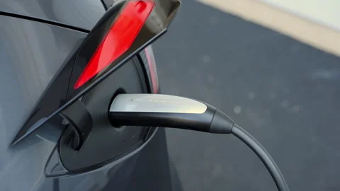 Close up of Tesla charging port. Plug in and disconnect of the Tesla charger Stock Footage 318496747