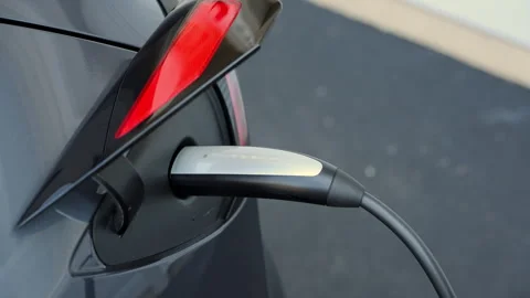 Close up of Tesla charging port. Plug in and disconnect of the Tesla charger Stock Footage 318628213