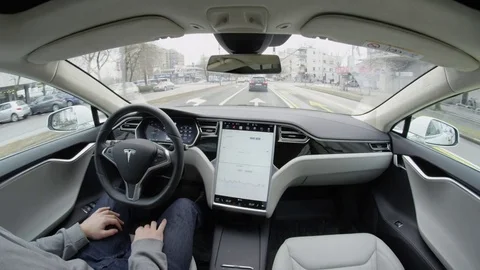 CLOSE UP: Tesla Model S self-driving autopilot autosteering in urban environment Stock Footage 72840437