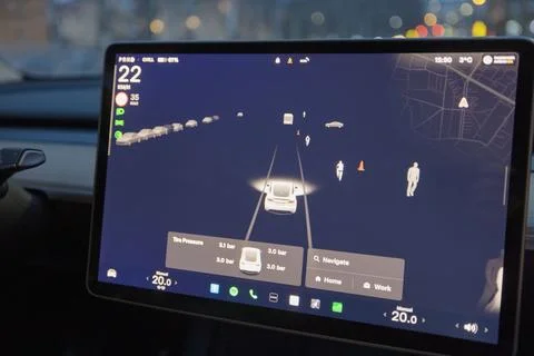 Close up of Tesla Model Y touchscreen with autopilot interface showing traffic Fotos de archivo