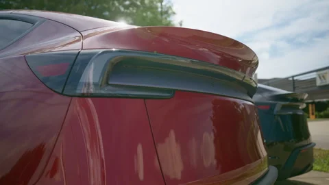 The close up of Tesla new electro mobiles. The dealership post displays the Stock Footage 312338211