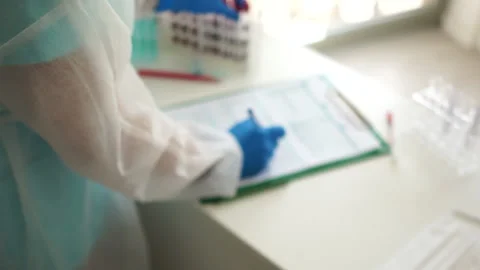 Close-up of a test tube labeled covid-19 positive test. Mass testing for Stock Footage 130670852