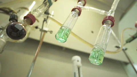 Close-up of test tubes boiling over a fire. slow motion.120 fps  Stock Footage 153863408