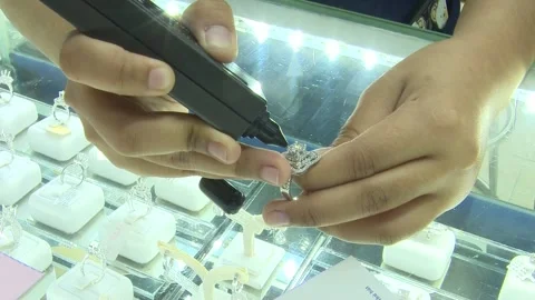 Close Up Testing Diamond Ring With Electronic Tester Pen Stock Footage 345502657