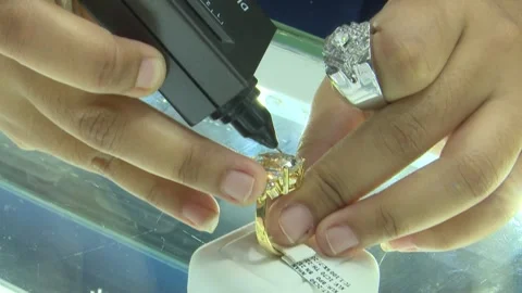 Close Up Testing Large Yellow Gold Diamond Ring On Counter Stock Footage 345502676