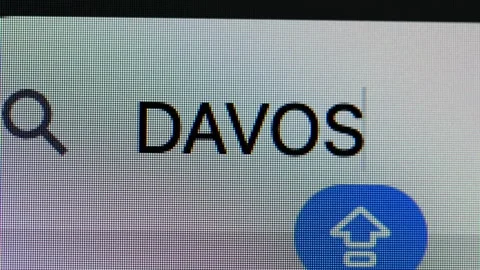 Close-up of text &amp;#039;DAVOS&amp;#039; in a search box Stock Footage 335732344