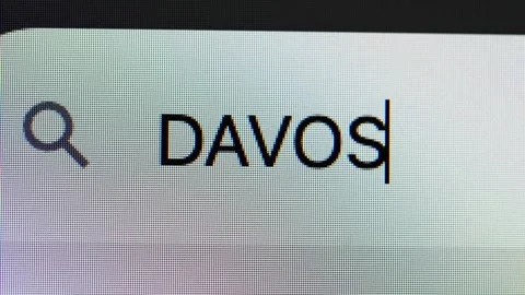Close-up of text &amp;#039;DAVOS&amp;#039; in a search box Stock Footage 335732362