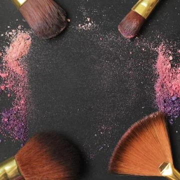 Close up. text frame with makeup brushes on black background Stock Photos