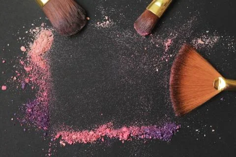 Close up. text frame with makeup brushes on black background Stock Photos