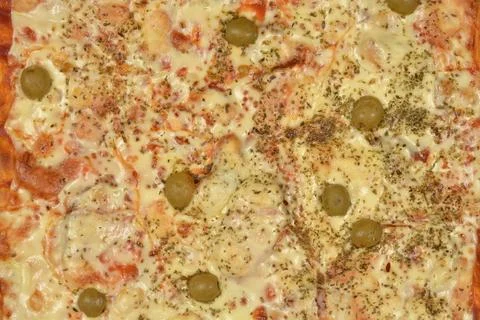 Close up texture background of a freshly baked pizza with olives Stock Photos