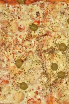 Close up texture background of a freshly baked pizza with olives Stock Photos