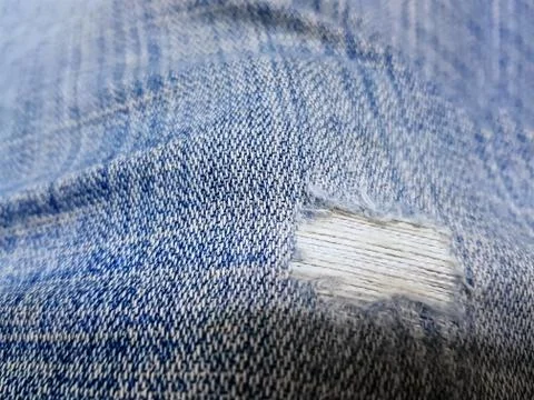 Close-up Texture Background of Ripped Denim Jeans Stock Photos