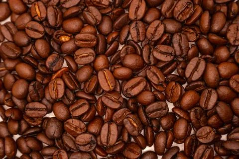 Close-up texture background of roasted brown coffee beans. Stock Photos