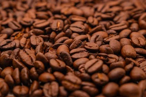Close-up texture background of roasted brown coffee beans. Stock Photos