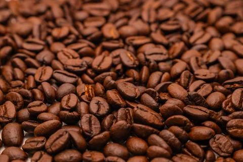 Close-up texture background of roasted brown coffee beans. Stock Photos