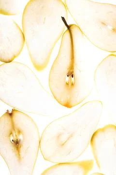 Close up texture of backlit illuminated pear slices. Autumn food concept Stock Photos