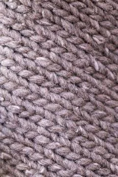 Close-up texture of beige knitted wool fabric with visible stitches and han.. Stock-Fotos
