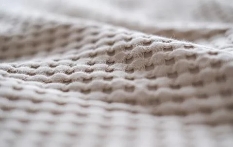 Close-up of the texture of a beige textile throw made from natural fabrics Stock Photos