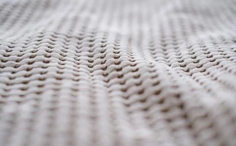 Close-up of the texture of a beige textile throw made from natural fabrics Stock Photos