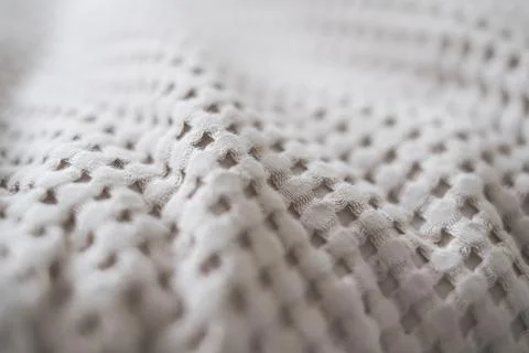 Close-up of the texture of a beige textile throw made from natural fabrics Stock Photos