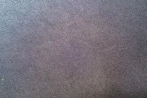 Close-up texture of black leather background with fine grain pattern, ideal for Stock Photos