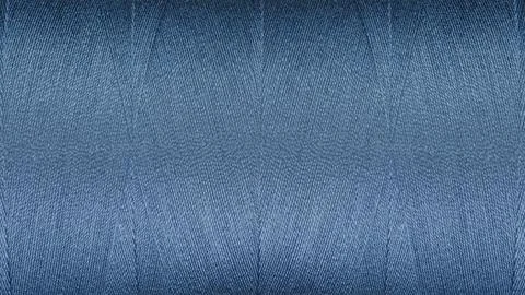 Close-up texture of Blue sewing threads on a spool Фото