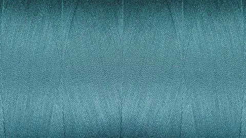 Close-up texture of Blue sewing threads on a spool Stock Photos