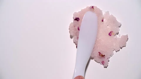 Close-up of the texture of body scrub smeared with spatula on white background Stock Footage 179477200