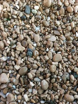 Close-up texture of brown pebbles on Cap d'Ail beach, French Riviera Stock Photos