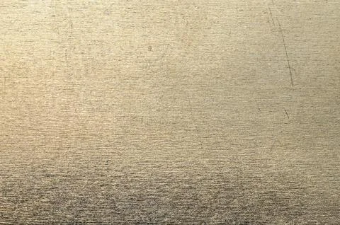 Close-up texture of brushed metallic surface with subtle scratches and refl.. Фото