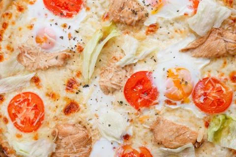 Close up texture of caesar pizza with cherry tomatoes, grilled c Stock Photos