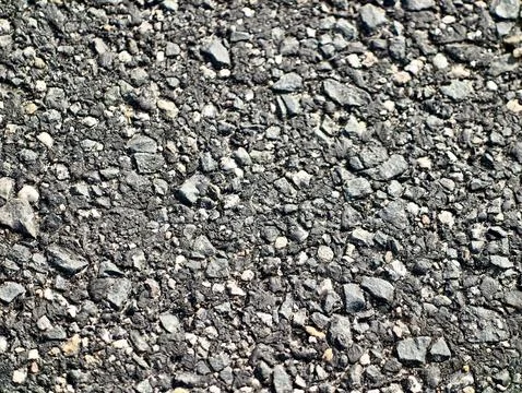 Close-up texture of coarse asphalt with scattered gravel Stock Photos