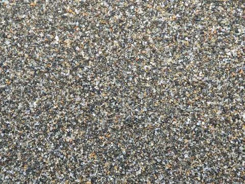 Close up texture of coarse beach sand mixture background seamless pattern Stock Photos