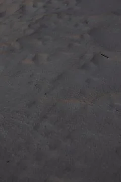 Close Up Texture of Dark Beach Sand Stock Photos