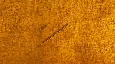 Close-up of the texture of a deep gold-coloured torn metal Foto stock