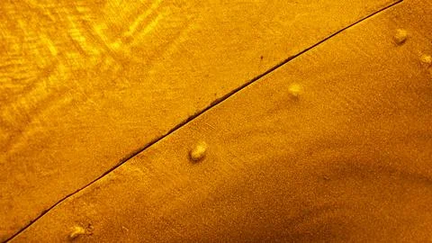 Close-up of the texture of a deep gold-coloured torn metal Stock Photos