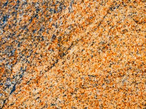 A close-up of a texture of a dressed red granite stone surface Stock Photos