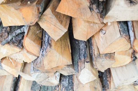 Close-up texture of dry fireplace logs. The surface of the campfire logs. Stock Photos