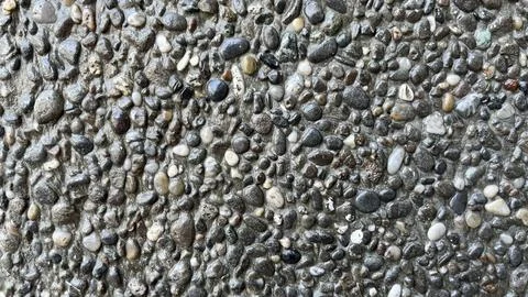 Close-up texture of exposed aggregate concrete surface 库存照片