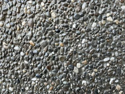 Close-up texture of exposed aggregate concrete surface Stock Photos