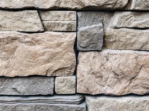 Close-up of texture of facing brick in gray and beige tones in the decoration Stock Photos