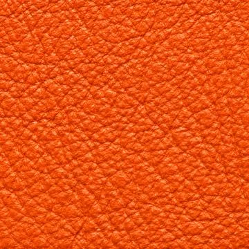 Close-up texture of fine bright orange pebbled leather grain Stock Photos