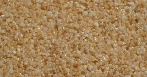 Close-up texture of fine marble chips. Small fraction. Ocher color. Video stock 169062191