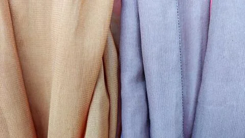 Close-Up Texture of Folded Beige and Purple Silk Fabric Stock Photos